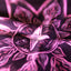 A close-up of a dark burgundy mulberry silk fabric with a bright pink starburst pattern. Hand rolled