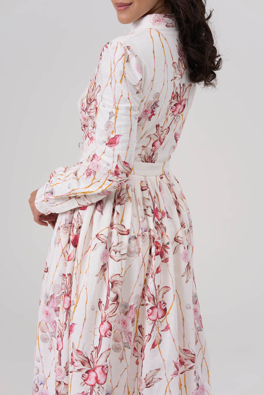 Woman wearing a floral dress with a white background