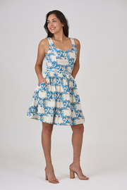 Woman wearing a blue floral dress on a white background