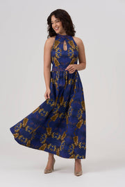 Woman wearing a blue and gold patterned dress on a white background