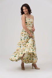 Woman wearing a white and green floral dress on a white background